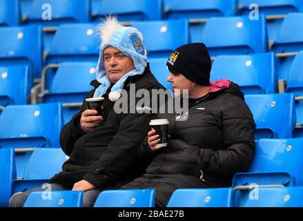 Manchester City fans in the stands Stock Photo