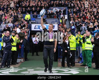 Great Britain's Olympic gold medal winner Sir Chris Hoy carries the match ball onto the pitch Stock Photo