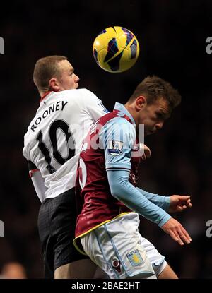 Manchester United's Wayne Rooney (left) and Aston Villa's Andreas Weimann in action. Stock Photo