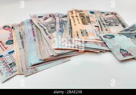 Money Spread on a white table | UAE Dirhams | United Arab Emirates currency | AED - Dhs | One hundred, five hundred, two hundreds and fifty bills Stock Photo
