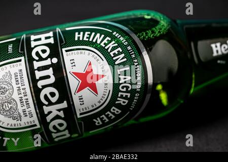 LONDON - MARCH 11, 2020: Heineken lager beer bottle on dark background Stock Photo