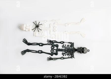 Black and white sceleton figures on white background. Black and white sides of human life. Contrast and opposite concept. Stock Photo