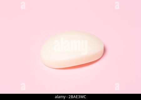 White bar of soap on pink background. Hugiene concept. Stock Photo