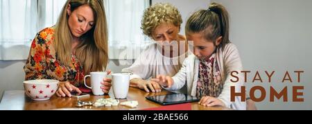 Three female generations using tablet and smartphone Stock Photo