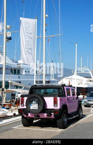 Puerto Banús, with luxury cars parked in port, Yachts behind