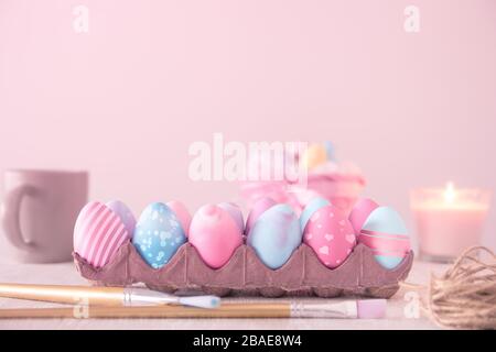 pastel colored painted Easter eggs in a carton with a variety of patterns - Easter holidays, celebrations and decorations concept  image with copy spa Stock Photo