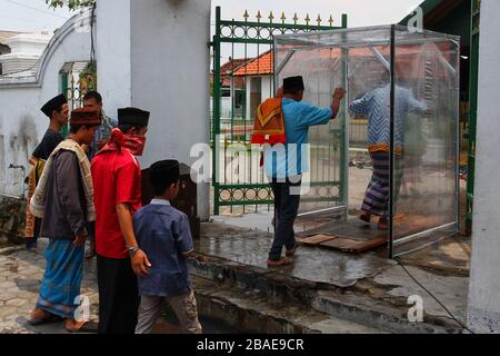 Yogyakarta, Indonesia. 27th Mar, 2020. People entered a disinfectant chambers to prevent the spread Coronavirus (Covid-19) while going to worship at the Ploso Kuning Mosque in Yogyakarta, Indonesia, Friday, March 27, 2020. Based on data Indonesian government reports, Indonesia has confirmed 1,046 cases of coronavirus and 87 cases of death. (Photo by Devi Rahman/INA Photo Agency/Sipa USA) Credit: Sipa USA/Alamy Live News Stock Photo