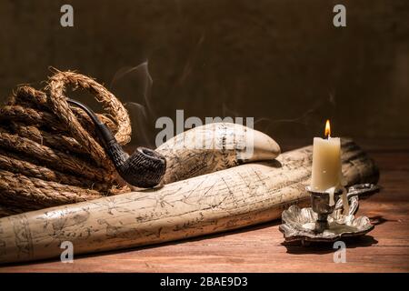 Vintage still life about fishing with a pipe and a sailor knife Stock Photo  - Alamy