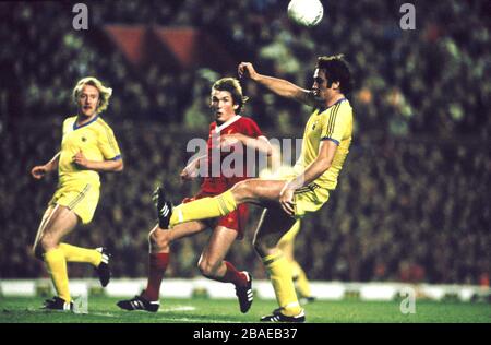 Nottingham Forest's Larry Lloyd (right) clears from Liverpool's Kenny Dalglish (centre), watched by teammate Kenny Burns (left) Stock Photo