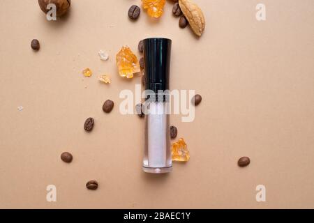 Cosmetics for natural makeup, Concealer for under-eye skin. Warm background with nuts coffee and dried fruits. Stock Photo