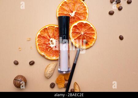 Cosmetics for natural makeup, Concealer for under-eye skin. Warm background with nuts coffee and dried fruits. Stock Photo