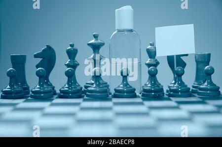 Coronavirus concept image chess pieces and hand sanitizer on chessboard illustrating global struggle against novel covid-19 outbreak. Stock Photo