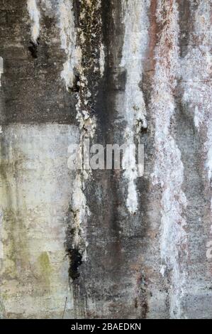 Abstract image of a grimy concrete wall in a railway underpass. Stock Photo