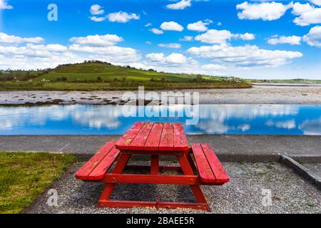 Red bench in the Irish countryside of the Cork area Stock Photo