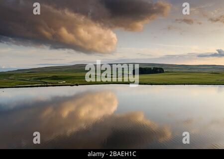 Clouds reflecting in water on Malham Tarn, Yorkshire Dales National Park Stock Photo