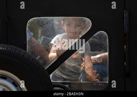 Boy peering out of a safari jeep while on tour in Minneriya National Park, Sri Lanka Stock Photo