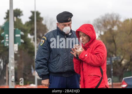 Thessaloniki, Greece - March 23, 2020: A police officer checks the documents of a citizen, as the country struggles to control the spread of the COVID Stock Photo