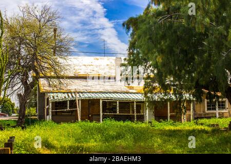 Old One Level Home With Overgrown Yard Stock Photo