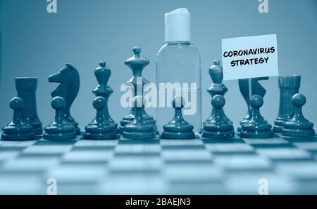 Coronavirus concept image chess pieces and hand sanitizer on chessboard illustrating global struggle against novel covid-19 outbreak with coronavirus Stock Photo