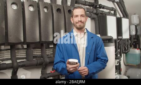 Young engineer smiling at camera with controller Stock Photo