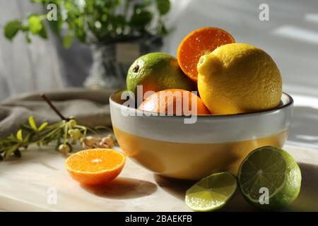 Still life with orange fruit and mint  on white marble top and canvas. Stock Photo