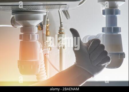 Work of plumber theme. Repair or install drain system in kitchen Stock Photo