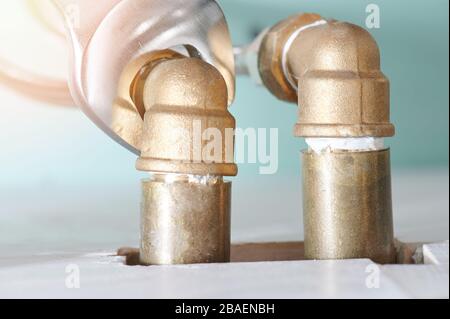Tighten pipe connections in sink with wrench close up view Stock Photo