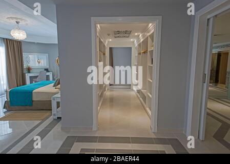 Interior of master suite luxury hotel room with large walk in wardrobe closet and bathroom Stock Photo
