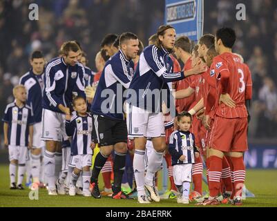 The two teams shake hands before kick-off Stock Photo