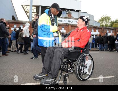 Fulham stewards help fans around the stadium on match day Stock Photo