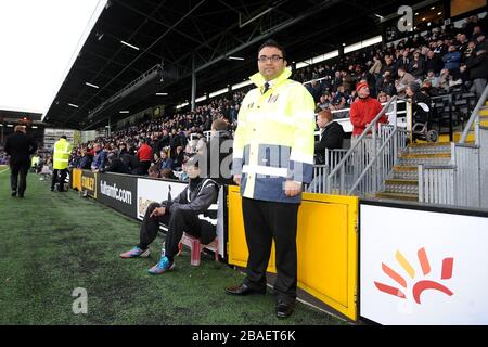 Fulham stewards help fans around the stadium on match day Stock Photo