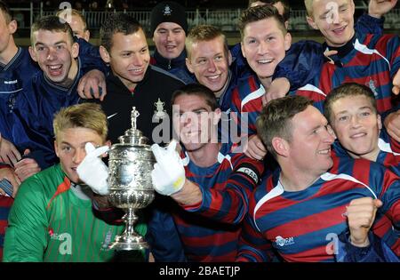 Lance Corporal James Hubbard, captain of the Royal Engineers football team holds aloft the original FA Cup after his team beat the Wanderers in a replay of the 1872 final Stock Photo