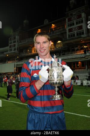 Lance Corporal James Hubbard, captain of the Royal Engineers football team holds aloft the original FA Cup after his team beat the Wanderers in a replay of the 1872 final Stock Photo