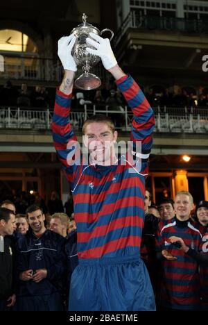 Lance Corporal James Hubbard, captain of the Royal Engineers football team holds aloft the original FA Cup after his team beat the Wanderers in a replay of the 1872 final Stock Photo