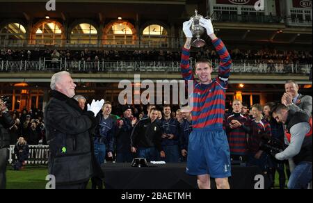 Lance Corporal James Hubbard, captain of the Royal Engineers football team holds aloft the original FA Cup after his team beat the Wanderers in a replay of the 1872 final Stock Photo