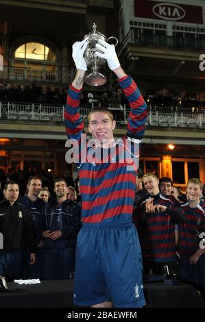 Lance Corporal James Hubbard, captain of the Royal Engineers football team holds aloft the original FA Cup after his team beat the Wanderers in a replay of the 1872 final Stock Photo