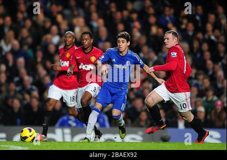 Manchester United's Wayne Rooney (right) chases after Chelsea's Emboaba Oscar (centre) Stock Photo