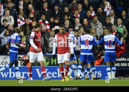 Arsenal's Francis Coquelin (right) and Ignasi Miquel (left) look dejected as Reading players celebrate their second goal of the game
