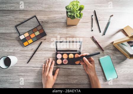 Professional makeup artist working at home - Fashion beauty influencer making self make up course applying brush - Cosmetic advertising concept Stock Photo