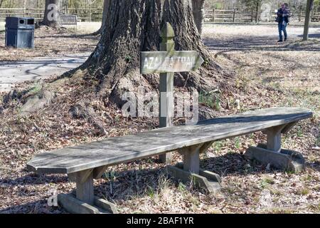 Hampton, Virginia/USA-March 1,2020: A wooden bench with a directional arrow sign pointing to the beginning of the Azalea Trail. Stock Photo
