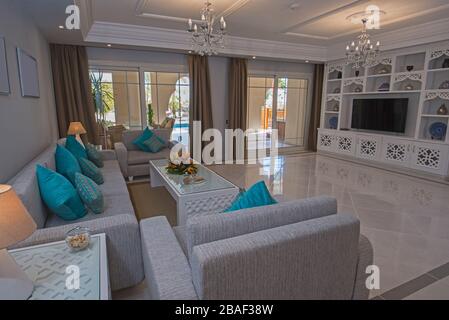 Living room lounge in luxury holiday villa show home showing interior design decor furnishing and outdoor terrace Stock Photo