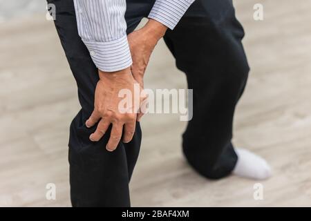 closeup hand holding knee pain elder man. Stock Photo