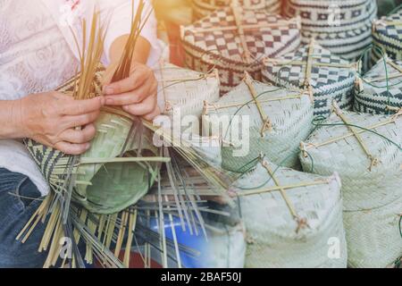 Thai OTOP handcraft products Thai style sticky rice box woven from Sugar Palm Leaf Lanna Handmade style. Stock Photo