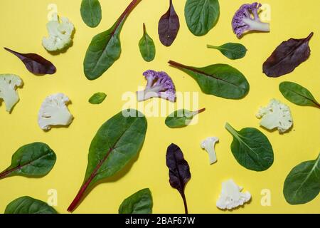 Sliced vegetables layout with leaves and tomatoes on background Stock Photo