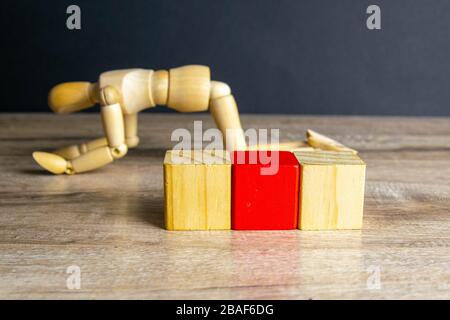 The concept of sadness, satomy, man became disillusioned with himself - wooden mannequin with surreal wood cube isolated on white background Stock Photo