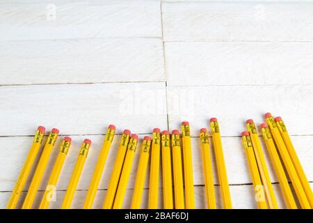 A set of orange pencils on a white wooden table. Printing supplies Stock Photo