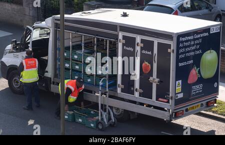 London, UK. 27th March 2020. Supermarket online orders are delivered to residential houses in south west London during the Coronavirus lockdown. Greatly increased demand for grocery deliveries has resulted in the major UK supermarkets notifying a 3 week wait for deliveries as older and vulnerable customers are given preference. Credit: Malcolm Park/Alamy Live News. Stock Photo