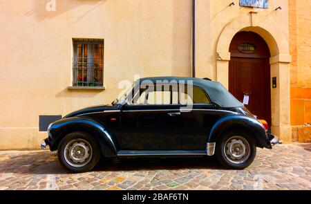 San Giovanni in Marignano, Italy - February 29, 2020:  Side view of black vintage car Volkswagen Beetle 1303 Cabriolet (1972—1980) parked in the stree Stock Photo