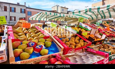 Faenza, Italy - February 27, 2020:  Market counter with various fruits in boxes at street market in Faenza in Italy Stock Photo