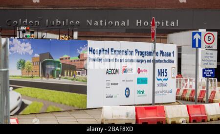 Glasgow, UK. 27th Mar, 2020. The Main entrance of the Golden Jubilee National Hospital in Clydebank. Work continues on the Hospital Expansion program, Credit: Colin Poultney/Alamy Live News Stock Photo